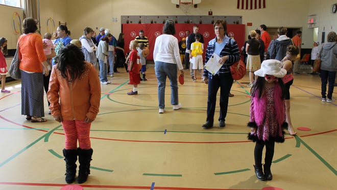 Fairview Elementary School third-graders wait for visitors to step on their “buttons” during the school’s fourth annual Wax Museum. Each of the students researched a famous past or present person and told the story of that person’s life whenever someone stepped on their button.