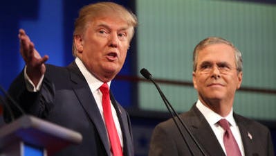 Republican presidential candidate Donald Trump speaks as Jeb Bush listens during the first Republican presidential debate at the Quicken Loans Arena Thursday, Aug. 6, 2015, in Cleveland. (AP Photo/Andrew Harnik)