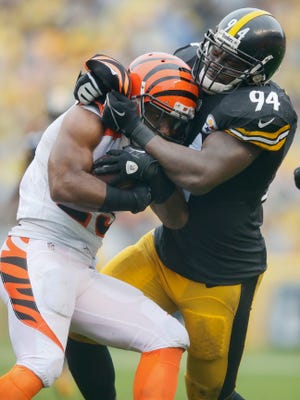 Cincinnati Bengals running back Giovani Bernard (25) is tackled by Pittsburgh Steelers inside linebacker Lawrence Timmons (94) in the second quarter during the Week 2 NFL football game between the Pittsburgh Steelers and the Cincinnati Bengals, Sunday, Sept. 18, 2016, at Heinz Field in Pittsburgh. At the half, Pittsburgh led, 10-6.