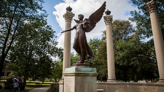 Students walk past Beneficence on Ball State's campus.