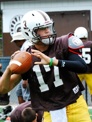 Roger Bacon quarterback Slaton Brummett works on his passing technique during a recent Roger Bacon football practice.