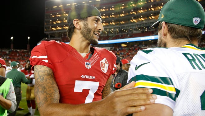San Francisco 49ers quarterback Colin Kaepernick, left, greets Green Bay Packers quarterback Aaron Rodgers at the end of an NFL preseason football game Friday, Aug. 26, 2016, in Santa Clara, Calif. Green Bay won 21-10.