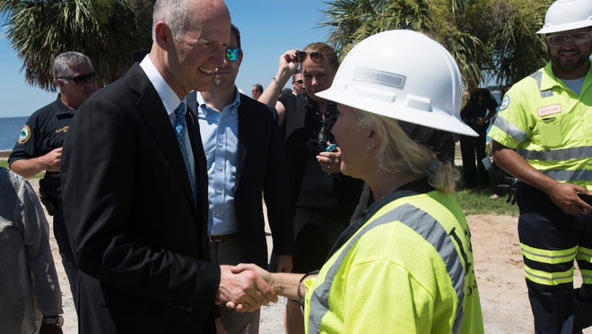 Governor Rick Scott, left, meets with construction workers at Wayside Park West during a visit to the $398 million Pensacola Bay Bridge construction project Monday morning June 26, 2016. During his visit Pensacola Scott, introduced the area to the state's new Chief Financial Officer, Jimmy Patronis.