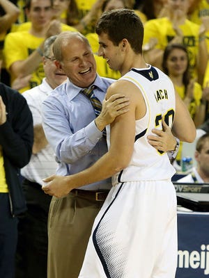 Michigan coach John Beilein greets Austin Hatch after his free throw late in U-M's exhibition win over Wayne State Monday in Ann Arbor.