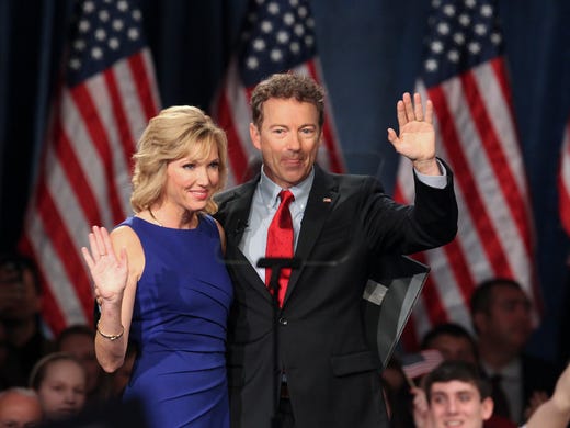 Sen. Rand Paul, right, waves to the crowd with his
