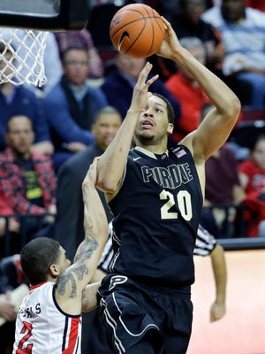 Purdue center A.J. Hammons (20) takes a shot as he is fouled by Rutgers guard Bishop Daniels (2) during the first half of an NCAA college basketball game, Thursday, Feb. 12, 2015, in Piscataway, N.J. (AP Photo/Mel Evans)