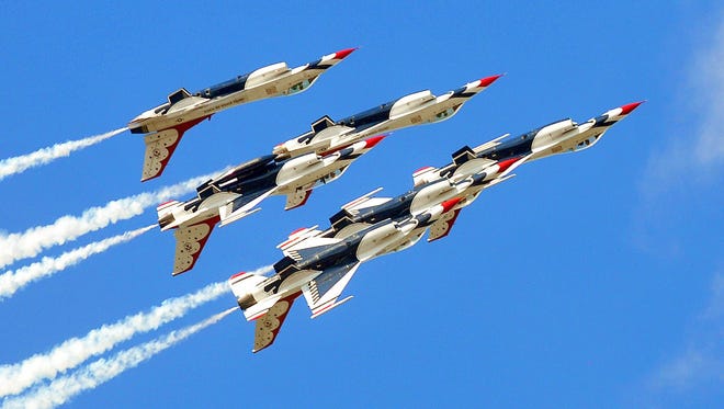 The United States Air Force Thunderbirds high in their Lockheed Martin F-16 Fighting Falcon's do some high speed aerial maneuvers for the Thousands of spectators who came out for Sunday afternoon's Tico Warbird Airshow in Titusville .