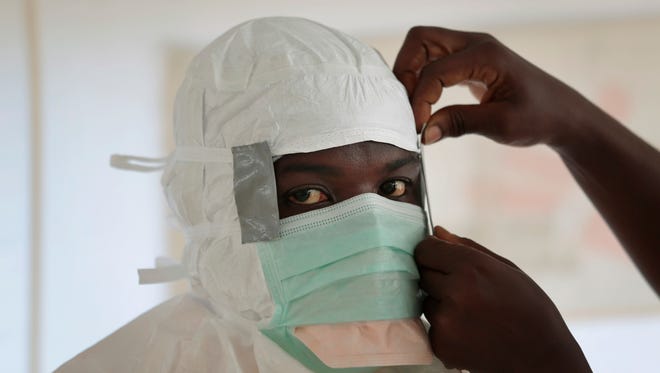 A nurse dons protective gear before entering a high-risk zone of an Ebola isolation and treatment center in Monrovia, Liberia, on Sept. 29, 2014.