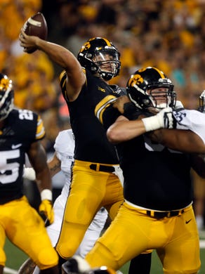 Iowa quarterback Nate Stanley throws down field during the Hawkeyes' game against No. 4 Penn State at Kinnick Stadium on Saturday, Sept. 23, 2017.