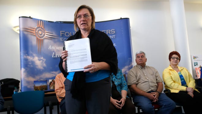 Aztec Mayor Sally Burbridge gives a presentation on proposed new federal rules for the oil and gas industry Thursday during a press conference at the Quality Center for Business at San Juan College in Farmington.