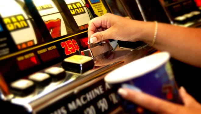 Hands playing slot machine