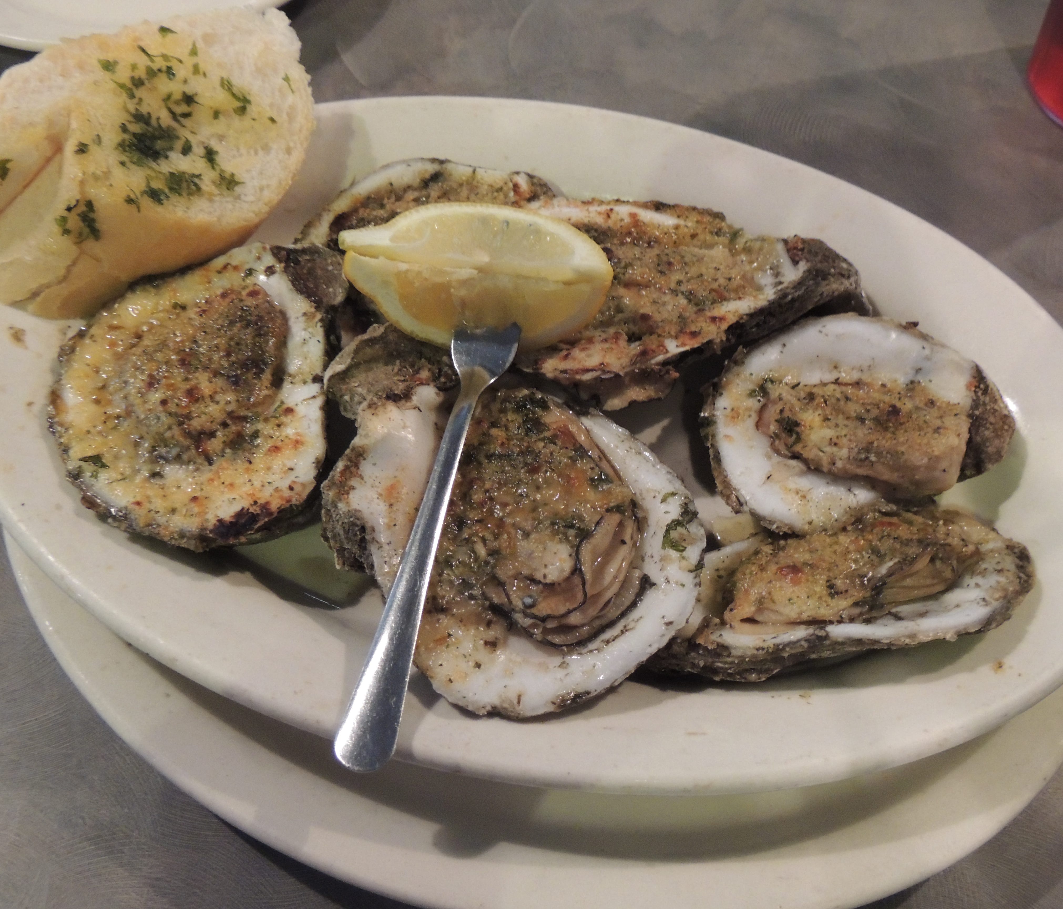 One of Dempsey's signature dishes is char grilled fresh Gulf oysters topped with garlic butter and cheese.