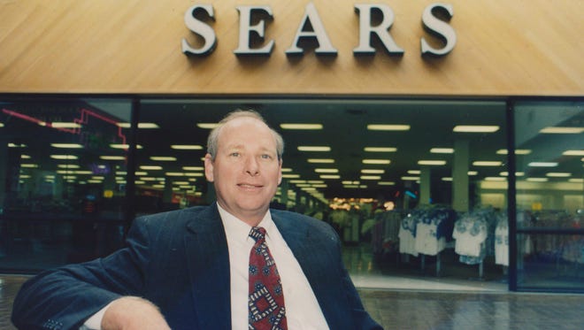 Store manager Jim Smith is shown in front of Sears in Sunset Mall in 1993.