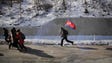 A boy runs with the national flag along the Pyongyang-Wonsan