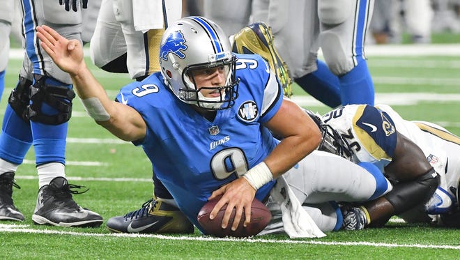 Matthew Stafford signals a first down in the fourth quarter against the Rams.