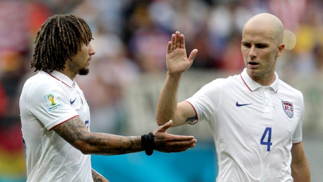 United States' Michael Bradley, right, congratulates his teammate Jermaine Jones after qualifying for the next World Cup round following their 1-0 loss to Germany during the group G World Cup soccer match between the USA and Germany at the Arena Pernambuco in Recife, Brazil, Thursday, June 26, 2014.