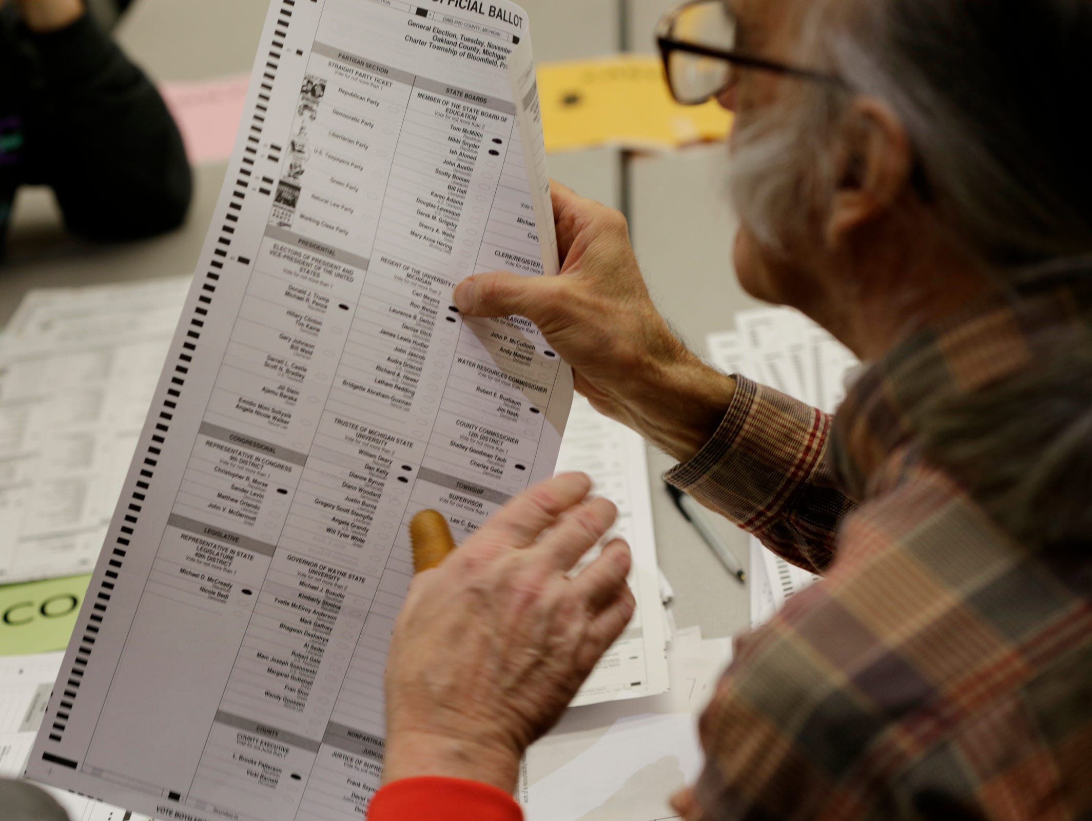 Votes are recounted at the Oakland County Intermediate School District in Waterford, on Tuesday, Dec. 6, 2016.