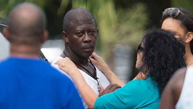 Kendrick Moore is comforted at the scene of the murder of Rodney Greenlee at the itersection of Cranford Avenue and Dr. Ella Piper Way in Fort Myers.  He was later arrested in Greenlee's death.  He was charged with second degree murder, possession of a firearm by convicted felonand use of a firearm during the commission of a felony.