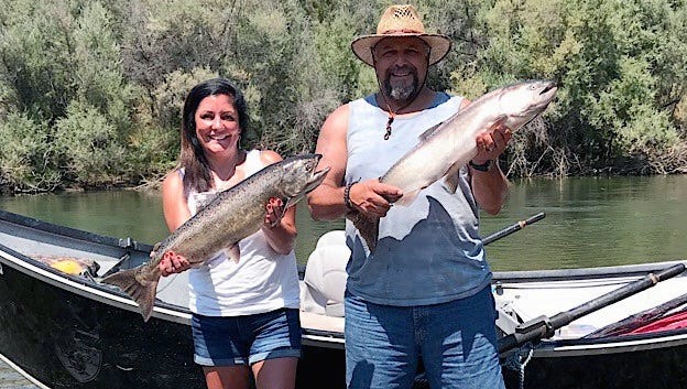 Don and Gina Ortega of Hayward pose with one of this month's "incredible double hookups" of king salmon on the Trinity River while out with Northern California salmon fishing guide Dave Jacobs.