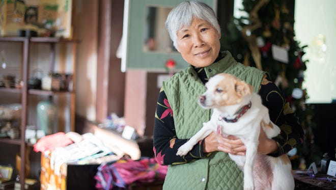 Ock Hee Hale is an esteemed gallery owner who retires this year. She is pictured with her dog, Lucy.