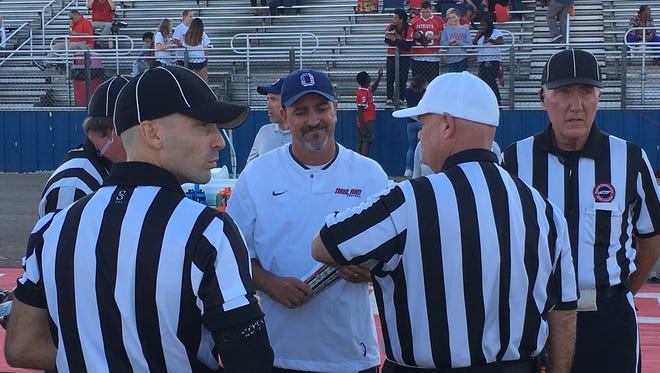 Oakland coach Kevin Creasy talks to officials prior to Friday's game against visiting Maryville on Friday August 25, 2017. 
