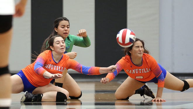 A trio of Canutillo volleyball players brace for impact as they go for the same dig Tuesday night against Horizon.