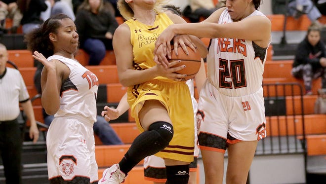 D’janique Wallace of Andress is blocked by El Paso High’s Mya Hernandez in the first half of their game Tuesady night at El Paso High School. 