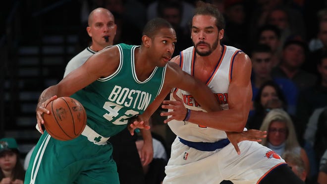 Al Horford #42 of the Boston Celtics drives into the lane against Joakim Noah #13 of the New York Knicks during the first half of their preseason game at Madison Square Garden on October 15, 2016 in New York City.