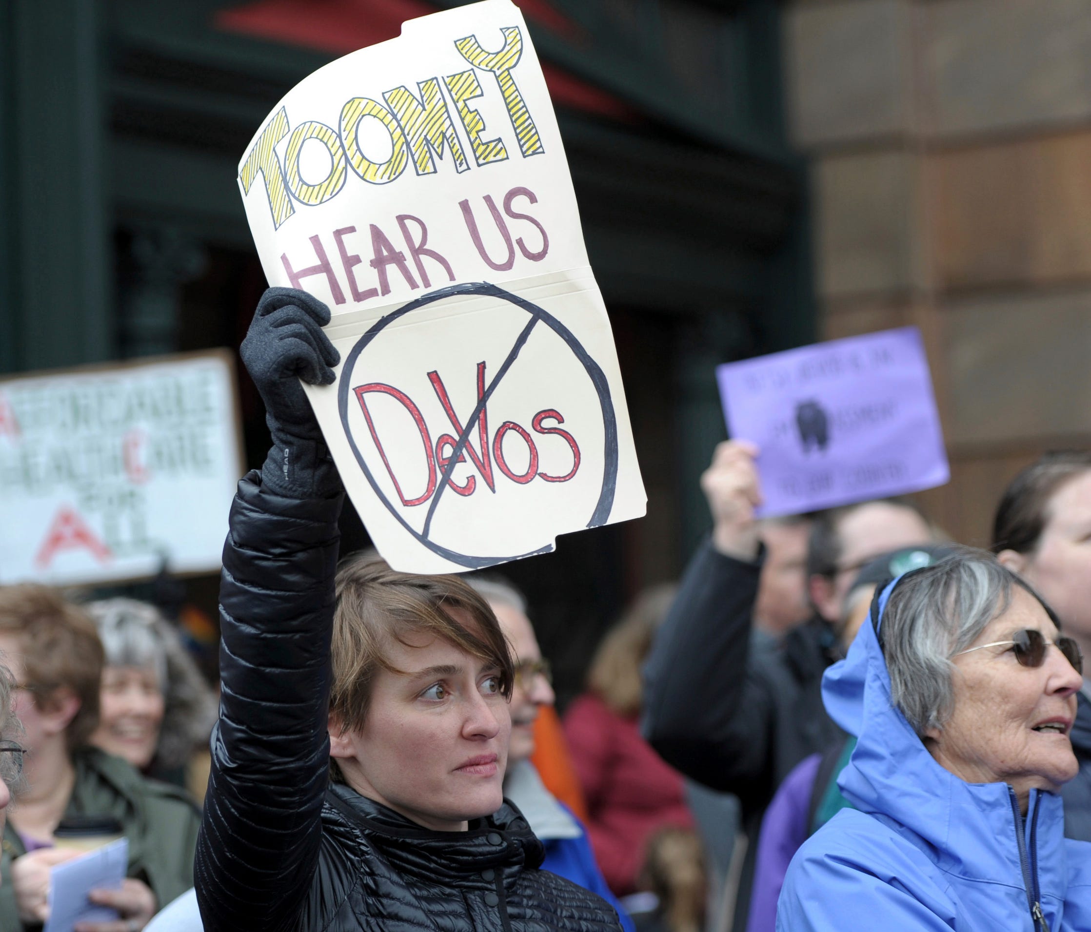 Emily Kane, from Highland Park, shows disapproval of the nomination of Betsy DeVos as Secretary of Education during a 