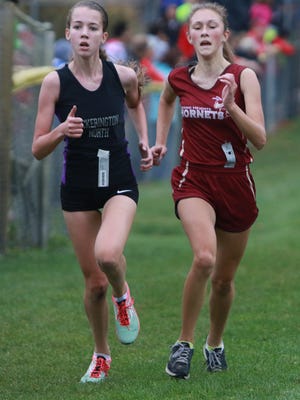 Licking Heights sophomore Kayla Wand, right, races to the finish with a Pickerington North competitor during the Division I, Section 1 district race at Watkins Memorial.