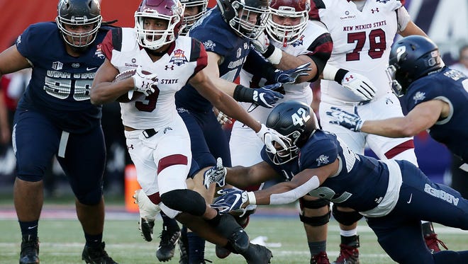New Mexico State Aggies running back Larry Rose III (3) breaks through the line for a big run during the second quarter between Utah State University and New Mexico State University in the NOVA Home Loans Arizona Bowl on Dec. 29, 2017, at Arizona Stadium in Tucson, Ariz.