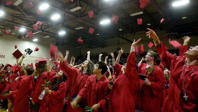 The Paris Gibson Education Center Class of 2015 tosses their caps in the air at the conclusion of Tuesday evening’s ceremony.