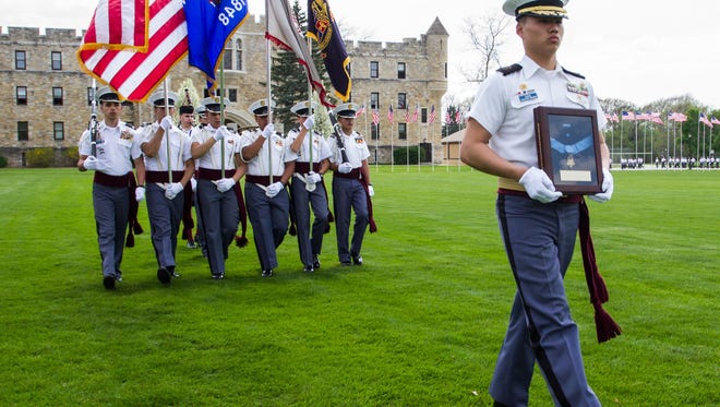 St. John's Northwestern Military Academy 1s5 Capt. Paddy Zheng carries the Medal of Honor posthumously awarded to 1st Lt. Alonzo H. Cushing during a ceremony at the academy in 2015. The school announced that starting in the summer of 2018, girls will be allowed to enroll there.