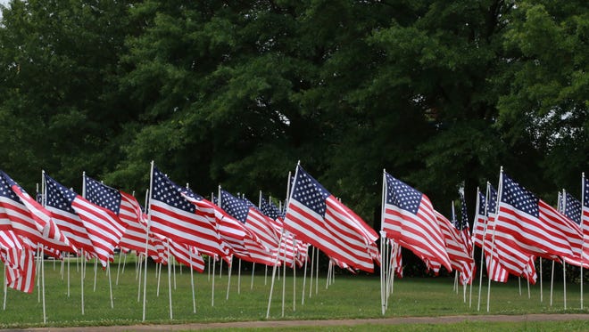 Almost 1,000 flags are placed on the lawn of First Cumberland Presbyterian Church by the Exchange Club-Carl Perkins Center for the Prevention of Child Abuse in honor of veterans, emergency responders, and children who died as a result of abuse or neglect.