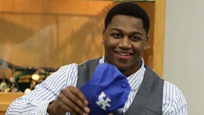 Former Trinity High School football player Jason Hatcher is shown here signing with Kentucky in February 2013.