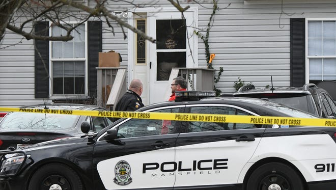 Coroner investigator Tom Stortz (right) at the scene of a February homicide. The instantaneous nature of social media is complicating law enforcement's efforts to notify next of kin in cases of death.