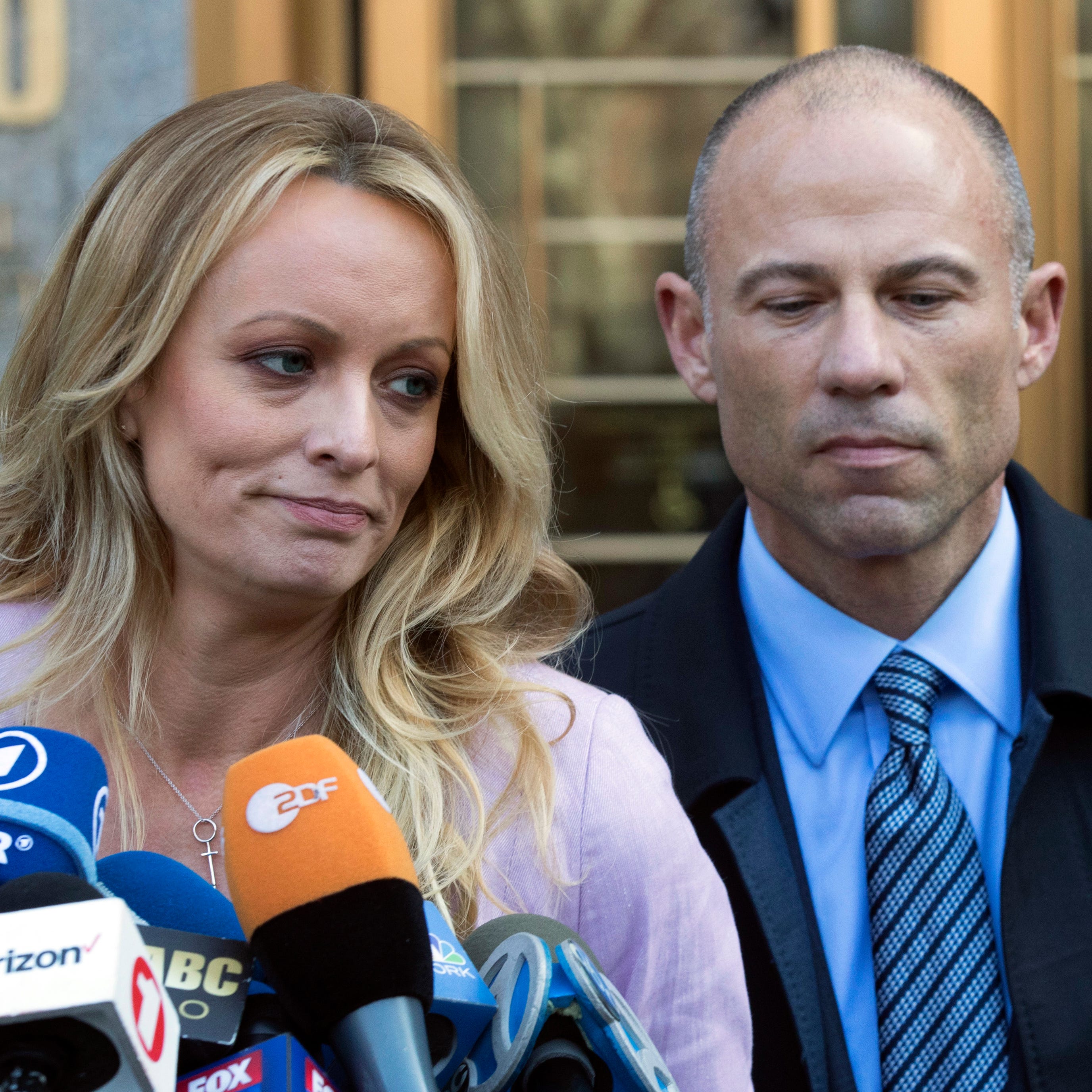 Adult film actress Stormy Daniels, left, stands with her lawyer Michael Avenatti as she speaks outside federal court Monday,