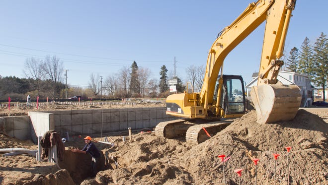 Contract workers for Chestnut Real Estate build a trench for one of two buildings that will comprise Chestnut Landing, a medical complex on Grand River in Genoa Township.
