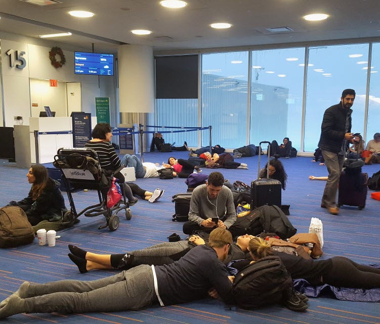 Passengers wait for their delayed flights at gate 15 in terminal five at John F. Kennedy International Airport on Jan. 4, 2018 in the Queens borough of New York City.