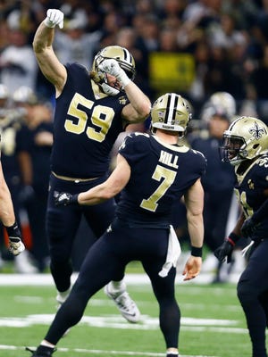 New Orleans Saints quarterback Taysom Hill (7) celebrates his first down carry on a fake punt, with linebacker Vince Biegel (59) in the first half of an NFL divisional playoff football game in New Orleans, Sunday, Jan. 13, 2019. (AP Photo/Butch Dill)