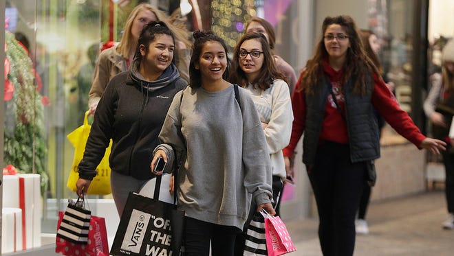 Shoppers packed malls and stores beginning in November and kept shopping right up until Christmas, a report released Tuesday shows. Consumers can expect more deals the rest of this week and through the new year, retail market watchers say.