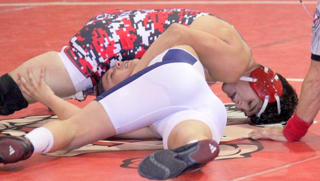 Cobre's Randy Maynes gave himself a birthday present Wednesday evening at home against Deming. He defeated Brandon Baca, 10-0, to help elevate the Indians to a 55-18 win. Above, Maynes tallies some back points.