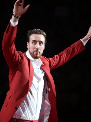 Former Wisconsin Badgers forward Frank Kaminsky greets fans during halftime as his number 44 is retired.