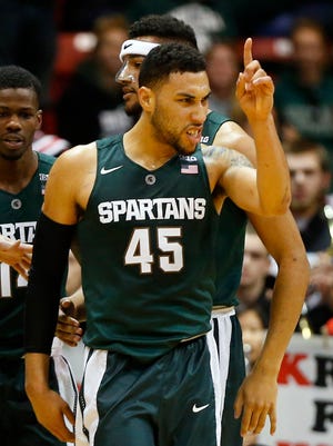 Michigan State's Denzel Valentine reacts after sinking a basket against Northeastern during the second half of a NCAA college basketball game in Boston Saturday, Dec. 19, 2015. (AP Photo/Winslow Townson)