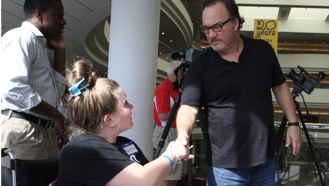 Musician and actor Jim Belushi shakes hands with MaryAnna Invergo, 13, while visiting and performing at Golisano Children's Hospital at HealthPark on Friday.