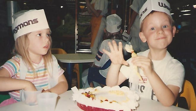 Kerri Lynn Smolinski (age 4), left, and her brother Karl (age 6) decorate a Mother's Day cake at Wegmans in the 1990s.