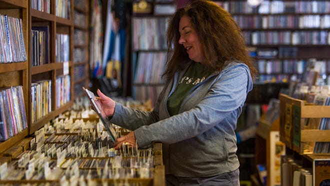 Groovacious owner Lisa Cretsinger looks through vinyl albums in her Cedar City record store Thursday.