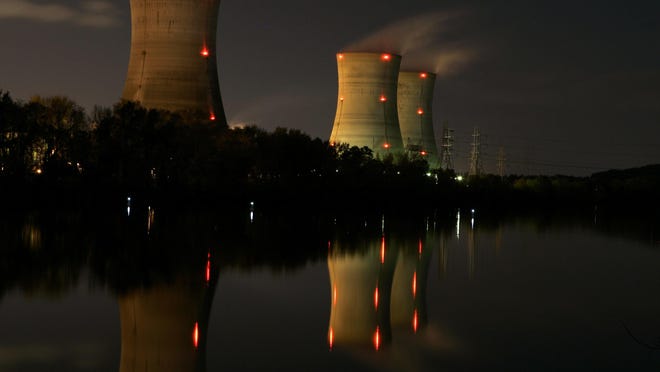 FILE - In this Nov. 2, 2006 file photo, cooling towers of the Three Mile Island nuclear power plant are reflected in the Susquehanna River in this time exposure photograph in Middletown, Pa. With nuclear power plant owners seeking a rescue in Pennsylvania, a number of state lawmakers are signaling that they are willing to help, with conditions. Giving nuclear power plants what opponents call a bailout could mean a politically risky vote to hike electric bills. (AP Photo/Carolyn Kaster, File)