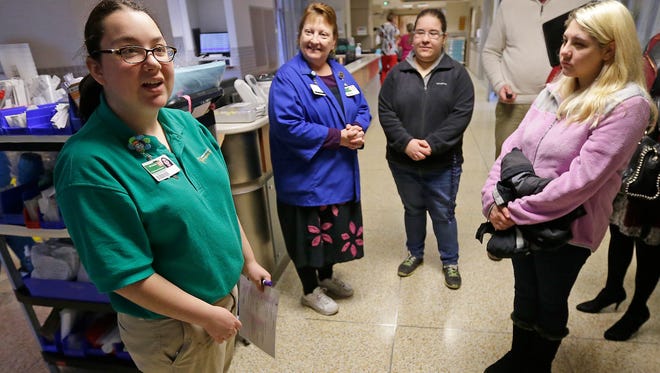 Project SEARCH intern Michaela Schroeder, left, explains her job in the Intensive Care Unit at St. Vincent Hospital Tuesday Feb. 9, 2015.