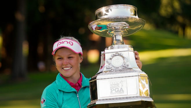 Brooke Henderson holds the KPMG Women's PGA Championship Trophy after winning in a play off following the final round at Sahalee Country Club - South/North Course in 2016.